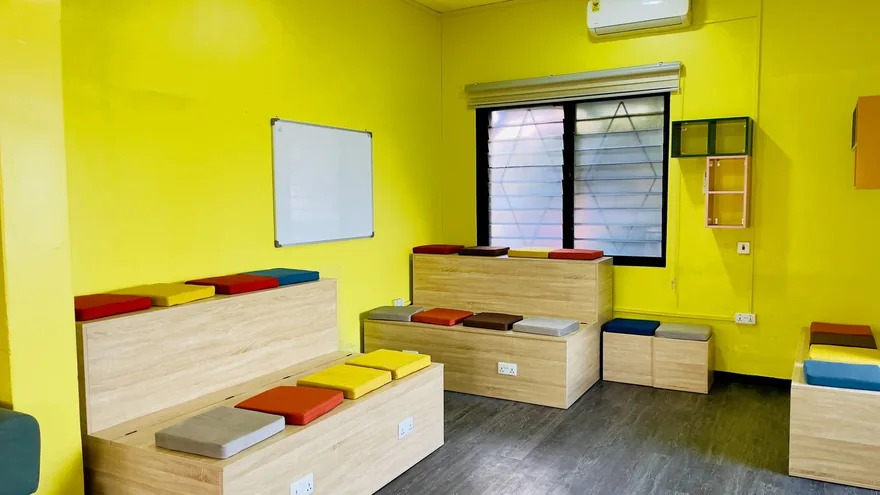Desks set for shared working, by the windows.