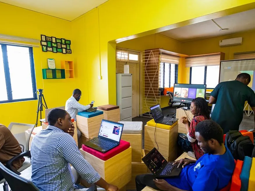 Founders heads-down at laptops on the open floor.